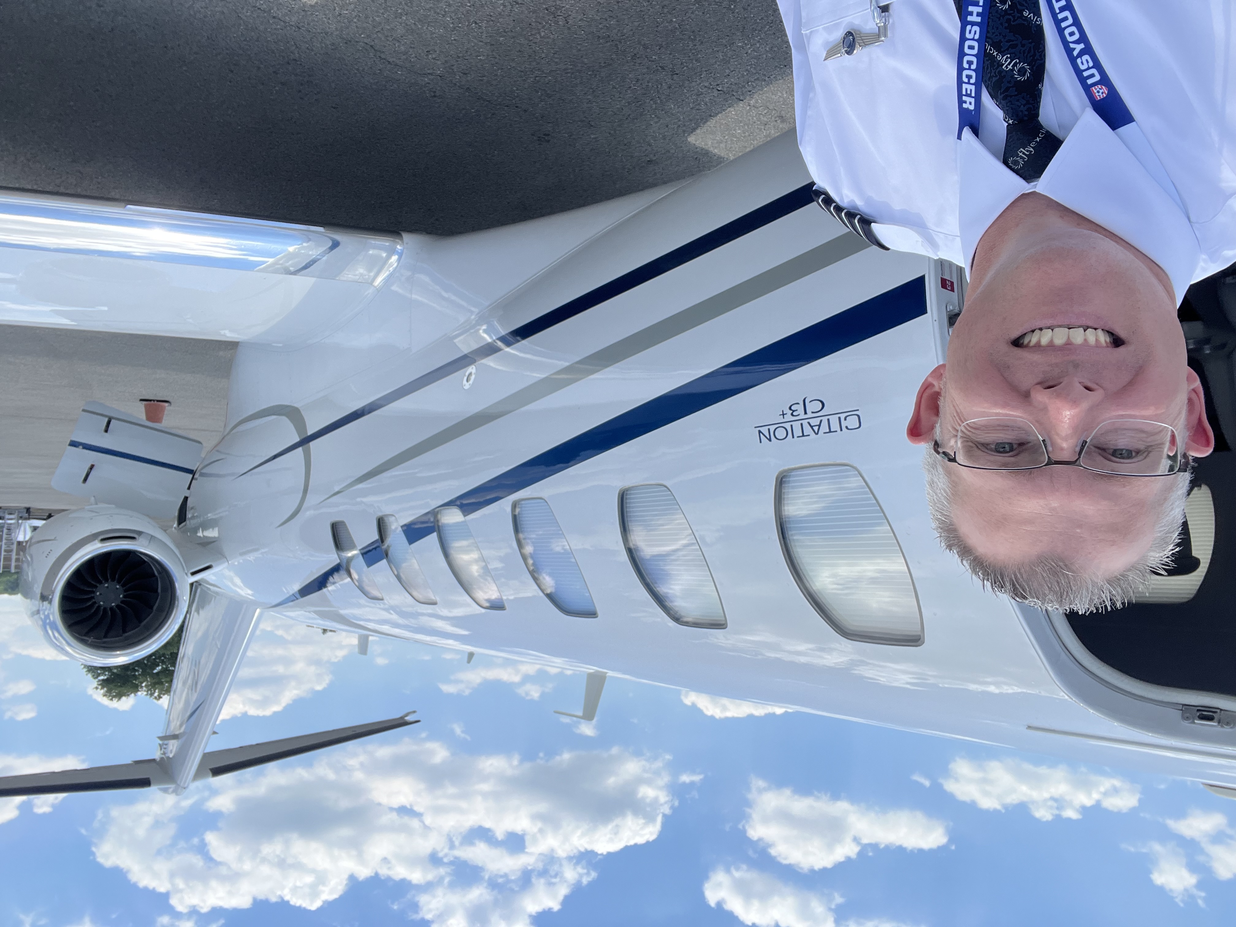 Travis Alkire in uniform next to a Citation CJ3+