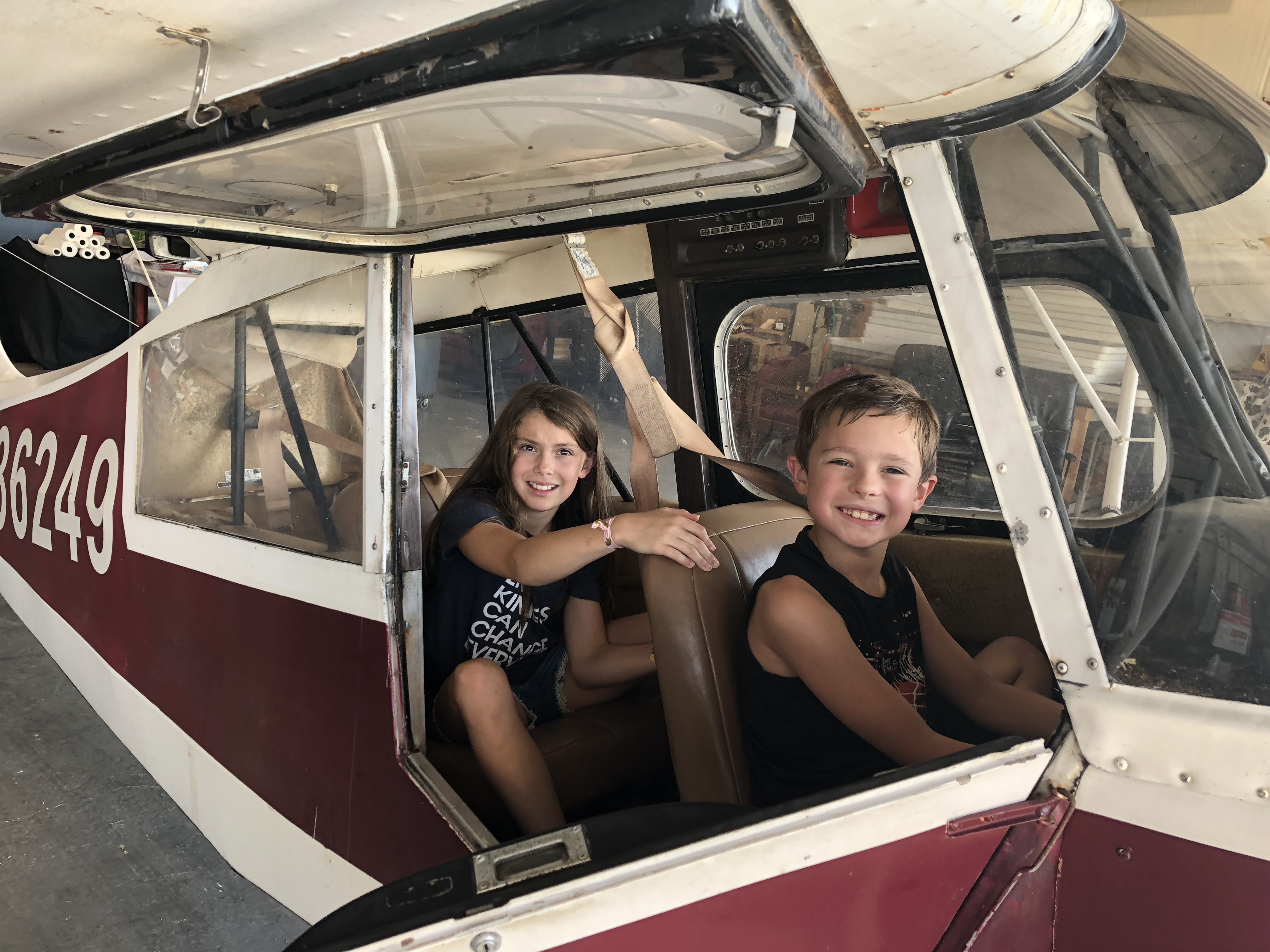 Kids exploring an airplane cockpit in the hangar